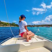 Woman on a boat in the blue lagoon of Vourvourou on peninsula Sithonia, Chalkidiki (Halkidiki), Greece